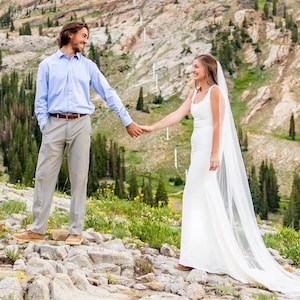 Simple wedding dress with soft square neckline.  Featuring a fit and flare silounette. Charmeuse satin or  Bridal Crepe fabric.