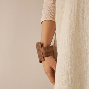 This bracelet made of wood is a perfect complement to the outfit and an excellent idea for a present.