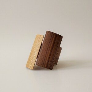 This unique wooden bracelet is handcrafted from walnut and oak wood veneer.