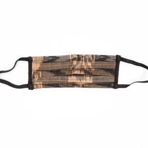 May include: A black and brown patterned face mask with black elastic ear loops.