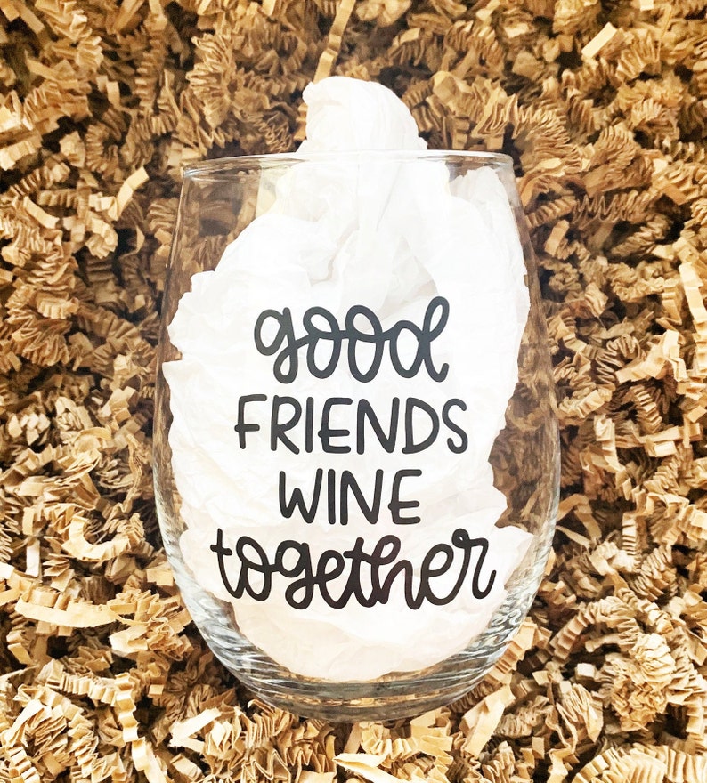 Może przedstawiać: Szklanka do wina z przezroczystego szkła z nadrukiem "good friends wine together" w kolorze czarnym na boku.