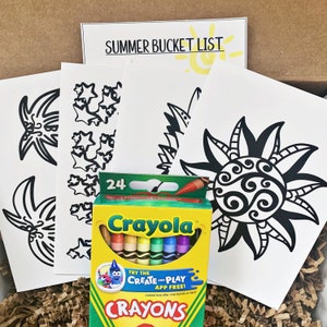 May include: A box of 24 Crayola crayons with a yellow background and the text "TRY THE CREATE AND PLAY APP FREE!"  The box is sitting on top of a pile of brown paper with four black and white coloring pages. The coloring pages feature a sun, stars, and a pineapple.