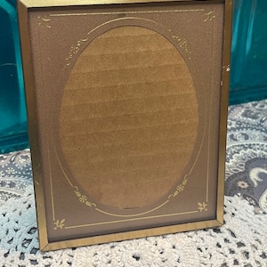 Vintage small metal photo frame with delicate  paper mat- aged