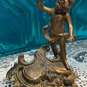 Antique or vintage ornate brass or bronze tone metal cherub statue - aged