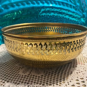 Vintage brass or brass tone perforated bowl with ball feet - showing it’s age