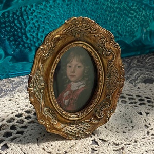 Vintage print of a boy in small ornate plastic frame Victorian style