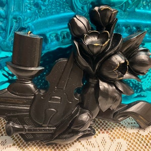 Vintage black plastic wall decor- candle - violin - flute- books - flowers