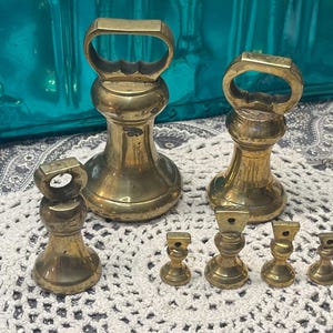 Antique set of 7 brass grocers weights- scale weights - different styles - aged