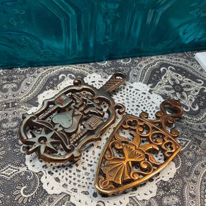 Vintage cast iron trivet with copper finish- heart- double eagle - set of 2- aged