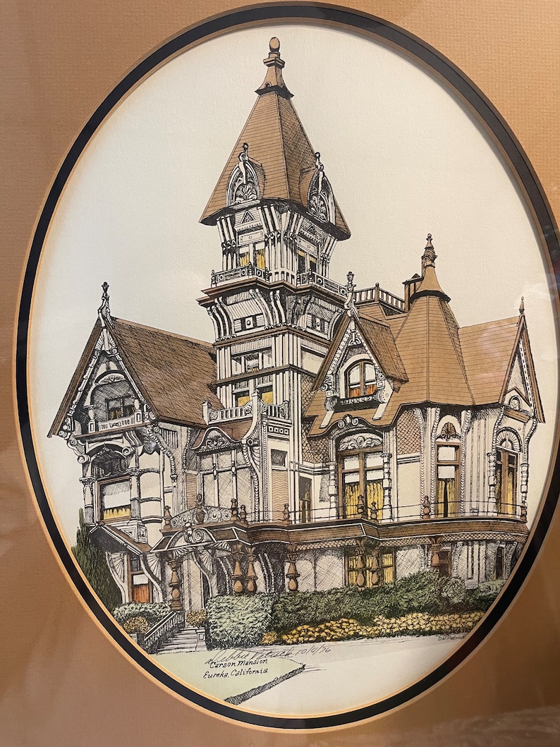 May include: A black and white pen and ink drawing of a Victorian mansion with a tower. The drawing is framed in a brown oval frame with a black border. The text "Carson Mansion, Eureka, California" is written below the drawing.