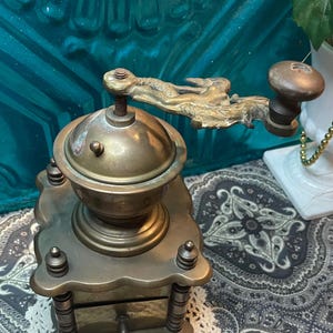 Antique heavy brass grinder with lady on dragon handle - aged- wear- non functional- decor only