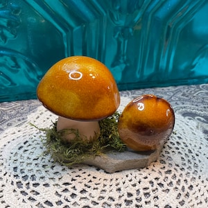 Vintage ceramic mushrooms on stone base