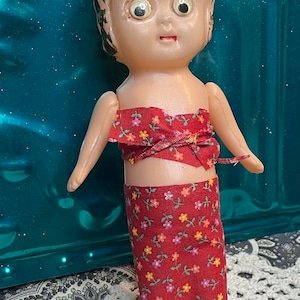 Vintage small plastic doll- movable arms - aged