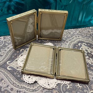 Vintage pair ofsmall gold tone metal photo frames  -floral details -bi fold slide in frames- wear on glass edges inside