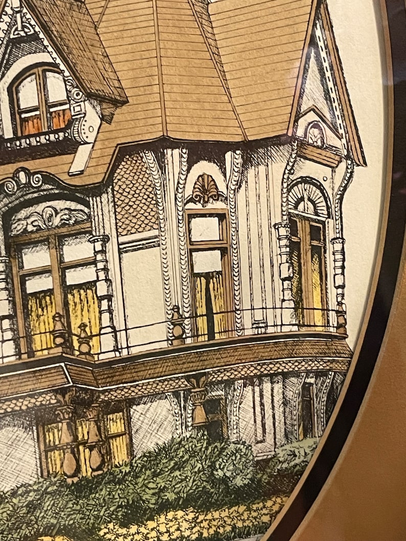 May include: A vintage illustration of a Victorian-style house with a brown roof, white walls, and intricate details. The house has multiple windows, a balcony, and a porch. The illustration is framed in a brown oval frame.