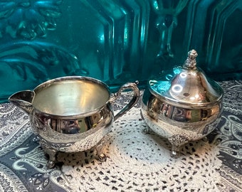 Vintage ornate footed silver plated creamer and sugar bowl