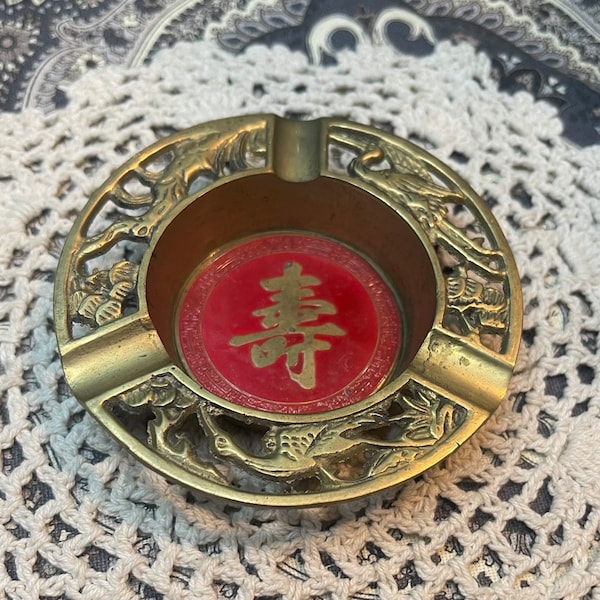 Vintage small brass ashtray with asian symbol and bird design - aged