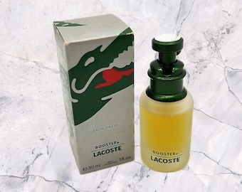 May include: A green and white box with a green alligator logo and the text "Booster Lacoste Eau de Toilette" and a 30 ml bottle of Booster Lacoste Eau de Toilette.