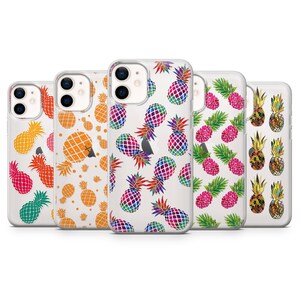 May include: Five clear phone cases featuring various pineapple designs. The cases have a white background with colourful pineapples. The pineapples are in different colours, including green, orange, red, and purple.