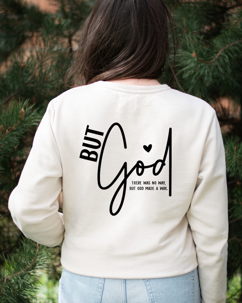 May include: White long-sleeved sweatshirt with black text that reads "BUT God THERE WAS NO WAY, BUT GOD MADE A WAY."