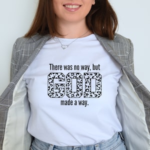 May include: White t-shirt with a black and white leopard print graphic that says "There was no way, but GOD made a way."