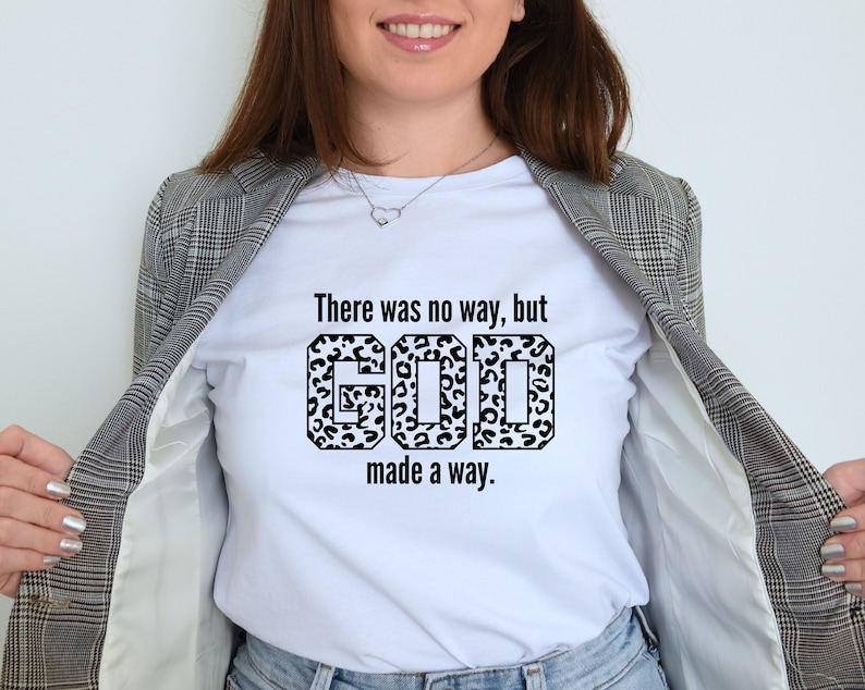 May include: White t-shirt with a black and white leopard print graphic that says "There was no way, but GOD made a way."