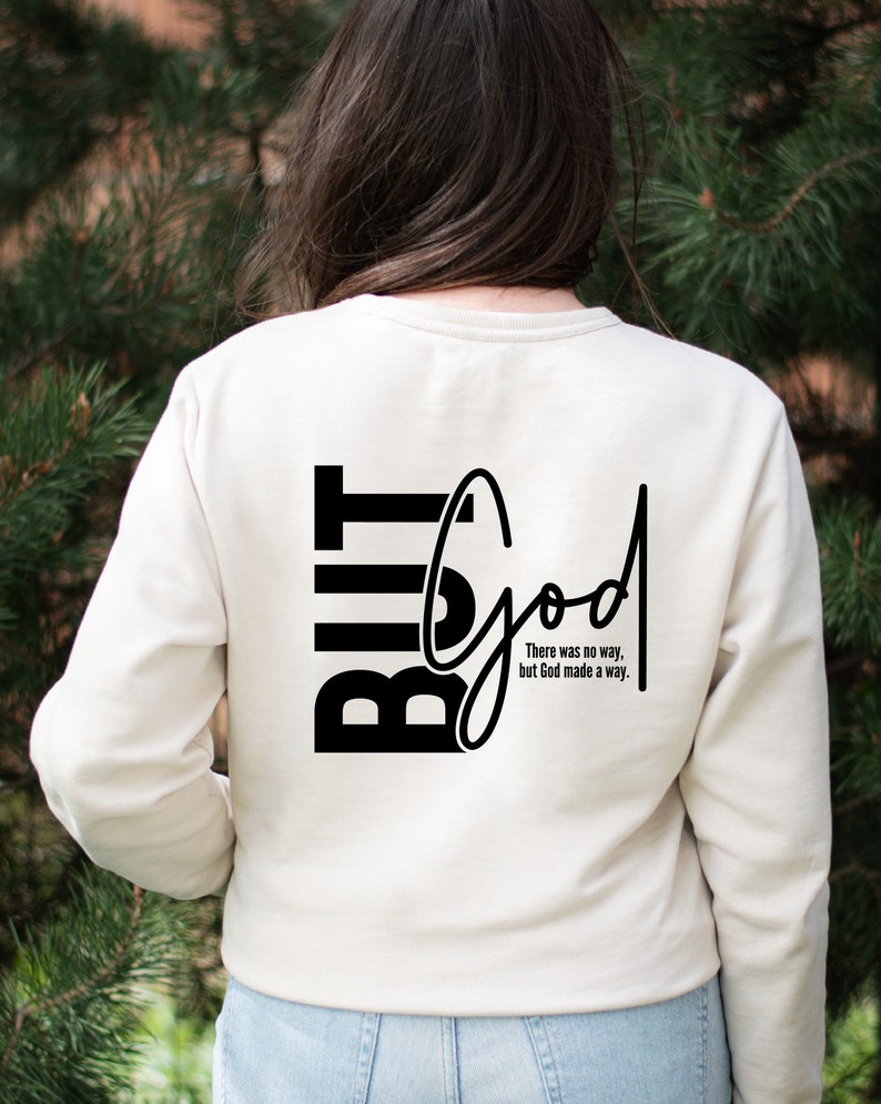 May include: A white long-sleeved shirt with black text that reads "But God" and "There was no way, but God made a way."