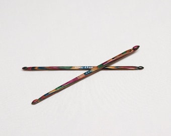 May include: Two wooden crochet hooks with colourful wood grain patterns. The hooks are 4.0mm - 4.5mm in size.