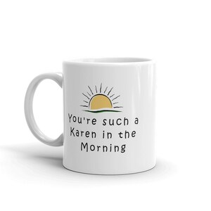 May include: White ceramic mug with a black and yellow sun graphic and the text "You're such a Karen in the morning".