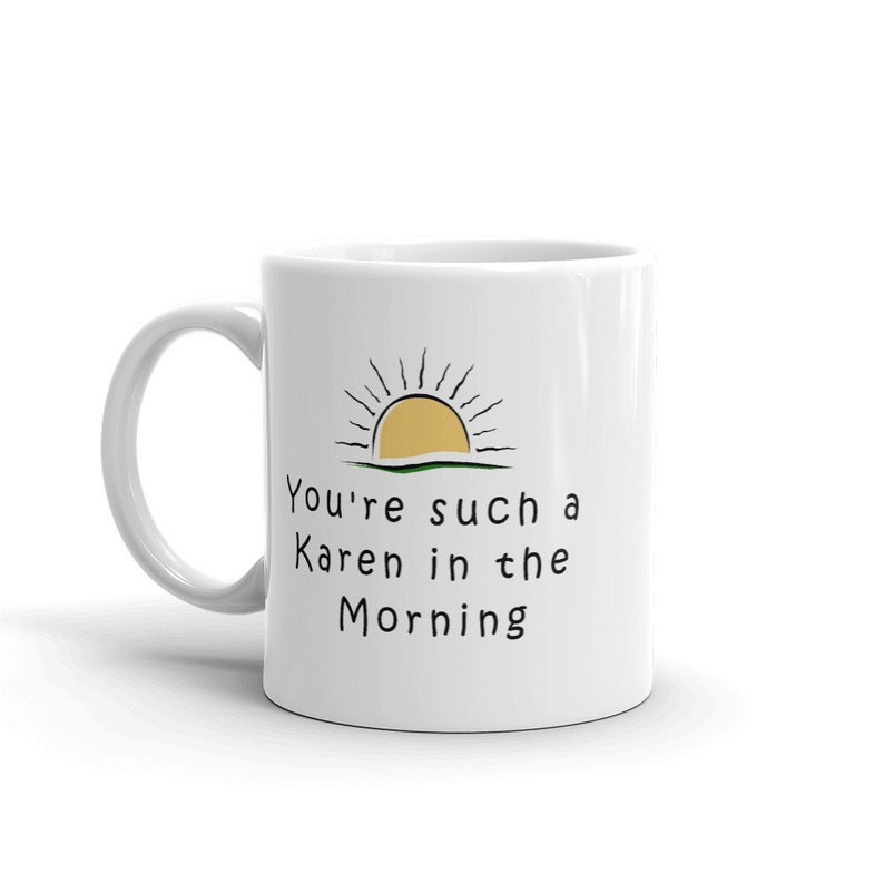 May include: White ceramic mug with a black and yellow sun graphic and the text "You're such a Karen in the morning".