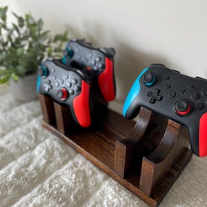 May include: A trio of ceramic mugs with a speckled, matte finish in cream, light grey, and dark grey. Each mug features a simple, minimalist design, ideal for tea or coffee.