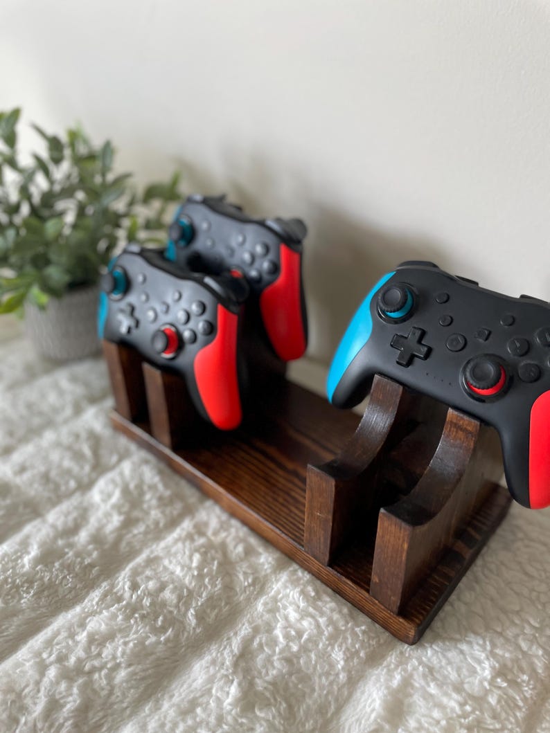 May include: A trio of ceramic mugs with a speckled, matte finish in cream, light grey, and dark grey. Each mug features a simple, minimalist design, ideal for tea or coffee.