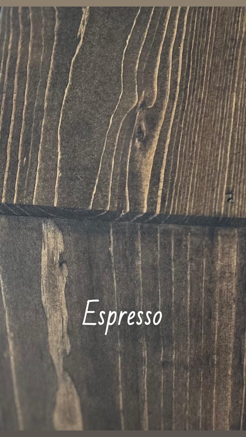 May include: A white ceramic mug with a black handle and the text "But First, Coffee" in a handwritten style. The mug is on a white surface. The mug is approximately 10 cm tall.