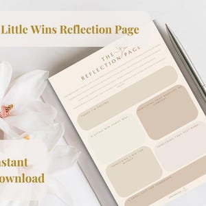 May include: A beige and white "Little Wins Reflection Page" with prompts for self-reflection. The page includes sections for writing about feelings, achievements, and challenges. A silver pen lies on the page. The words "Little Wins Reflection Page" are at the top.