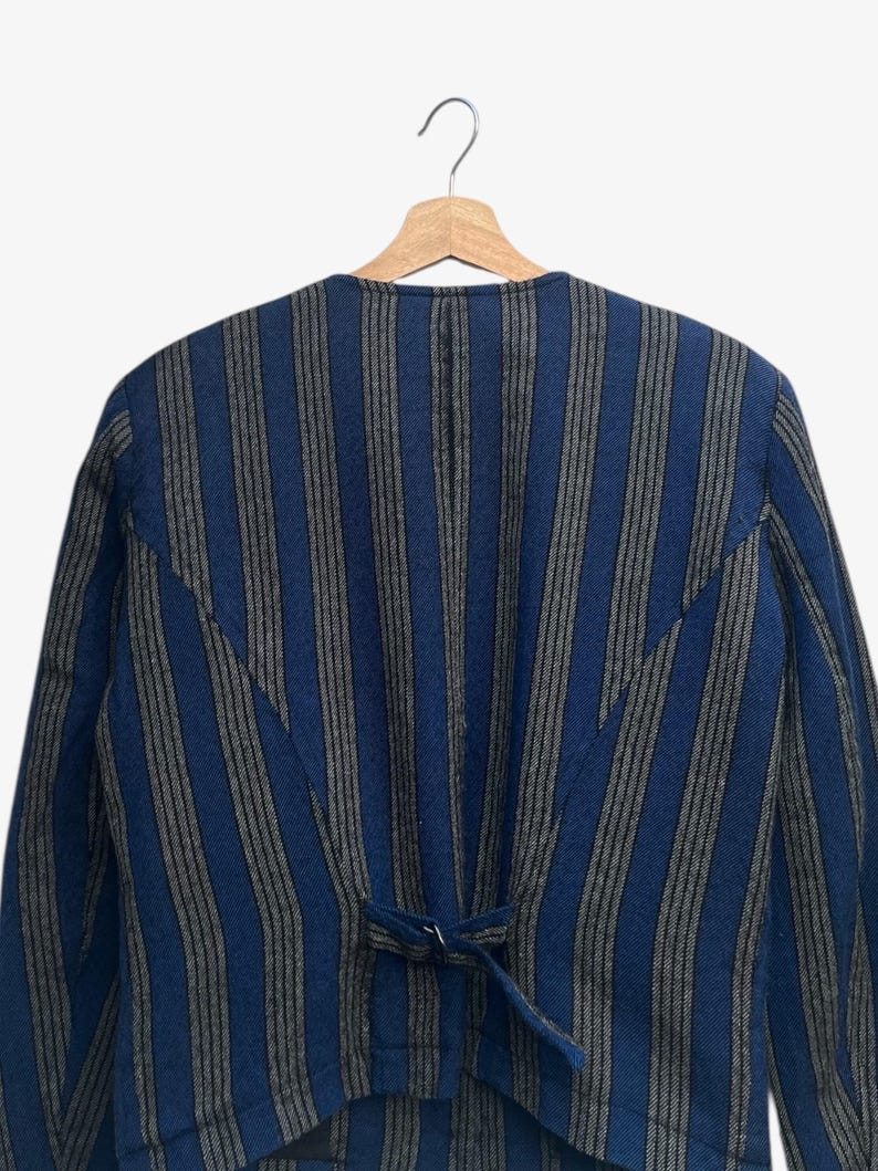 May include: A set of three ceramic mugs with a speckled, matte finish. The mugs are in shades of cream, light gray, and dark gray. Each mug has a simple, minimalist design and a rounded handle.