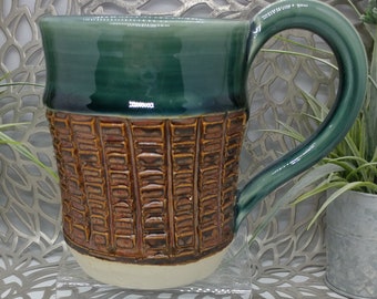 Hand thrown textured 16 oz porcelain mug in antique copper and dark green celadin