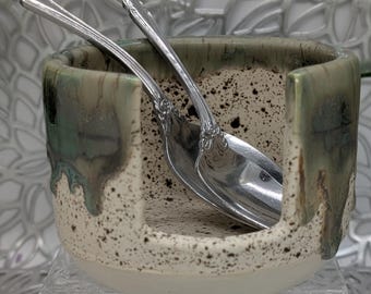 Hand thrown and carved vertical spoon holder in green metallic in places brown and brown speckled cream glaze combination, 4x2.9