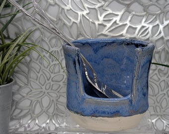 Hand thrown and carved vertical spoon holder in dark mottled blue glaze. 3.75x3.5.