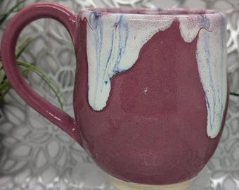 Hand thrown 20 oz footed porcelain coffee cup in hot pink and white with blue drips.