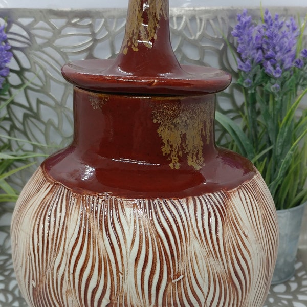 Stunning hand thrown porcelain bottle embossed with flames and glazed in firebrick and gold, 6.5x9