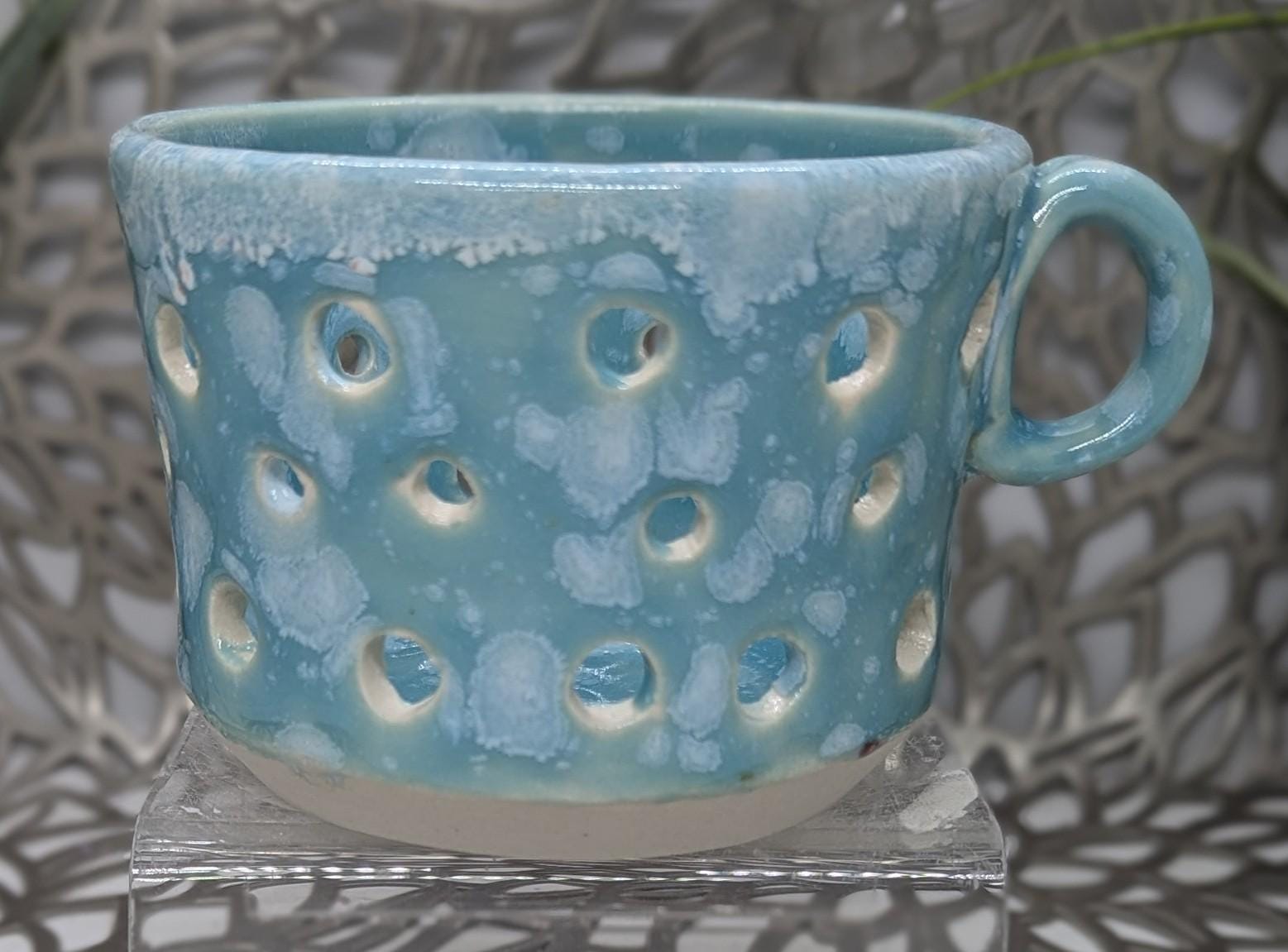Hand thrown vented porcelain votive candle holder in pale green celadon with white color bursts, 4x3