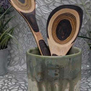 Hand thrown pot of many uses in green metallic in places brown and brown speckled cream glaze, 41.x4.4,22 oz.