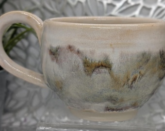 Hand thrown and trimmed 16 oz footed short porcelain coffee cup in honey cream and gold brown earth tone glaze.