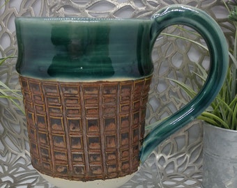 Hand thrown 15 ounce textured porcelain mug in dark green celadon and antique copper