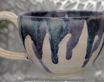 Hand thrown and trimmed 22 oz footed porcelain soup bowl in honey cream, dark blue and dark purple maroon.