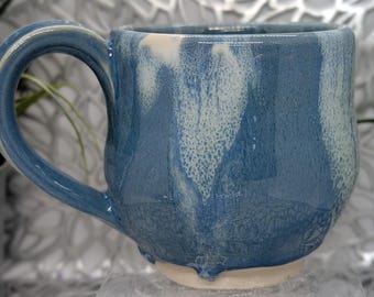Discounted hand thrown 14 oz footed porcelain coffee cup in Oasis blue and white glaze