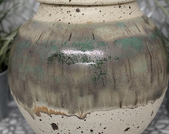 Hand thrown and trimmed lovely 14 cup earth tone jar/urn in green which is metallic in places brown and brown speckled cream glaze,7.5x9.