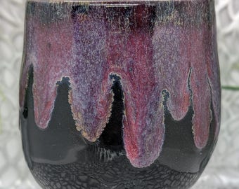 Hand thrown and trimmed footed 18 oz porcelain tumbler in obsidian purple maroon and gold glaze.