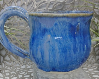 Hand thrown 18 oz porcelain mug in weeping blue glaze