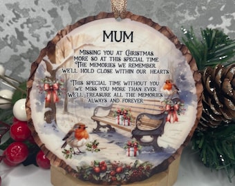 May include: A round wooden ornament with a winter scene and the text "MUM MISSING YOU AT CHRISTMAS. MORE SO AT THIS SPECIAL TIME. THE MEMORIES WE REMEMBER. WE'LL HOLD CLOSE WITHIN OUR HEARTS THIS SPECIAL TIME WITHOUT YOU. WE MISS YOU MORE THAN EVER. WE'LL TREASURE ALL THE MEMORIES. ALWAYS AND FOREVER"